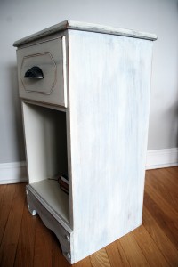Side view of the milk-painted bedside table